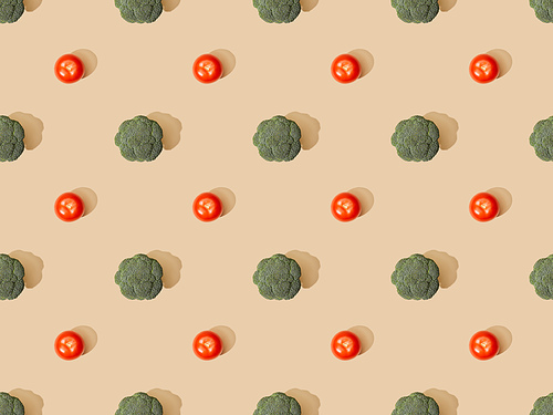 top view of fresh green broccoli and tomatoes on beige background, seamless pattern