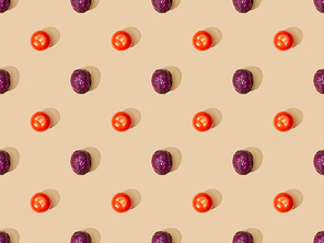 top view of whole ripe red cabbage and tomatoes on beige background, seamless pattern