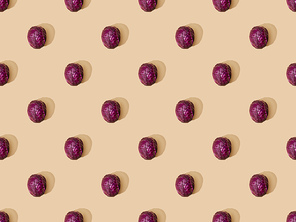 top view of whole ripe red cabbage on beige background, seamless pattern
