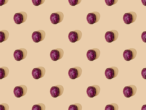 top view of whole ripe red cabbage on beige background, seamless pattern
