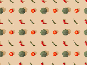 top view of red spicy chili peppers and jalapenos with broccoli and tomatoes on beige background, seamless pattern