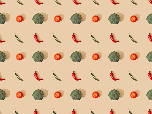 top view of red spicy chili peppers and jalapenos with broccoli and tomatoes on beige background, seamless pattern