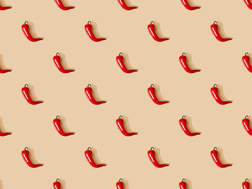 top view of red spicy chili peppers on beige background, seamless pattern