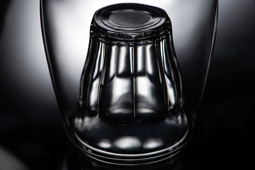 close up view of shot glass in wine glass in dark