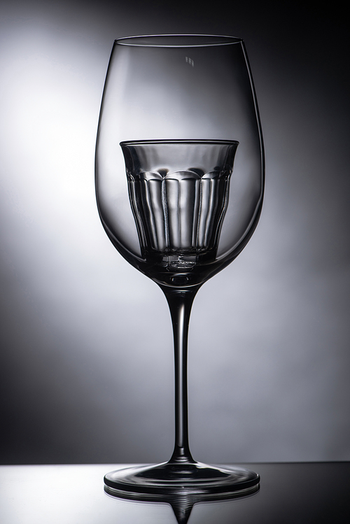 empty shot glass in wine glass on dark background