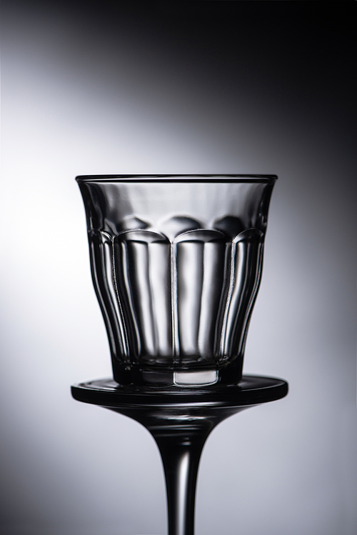 close up view of empty shot glass on dark background
