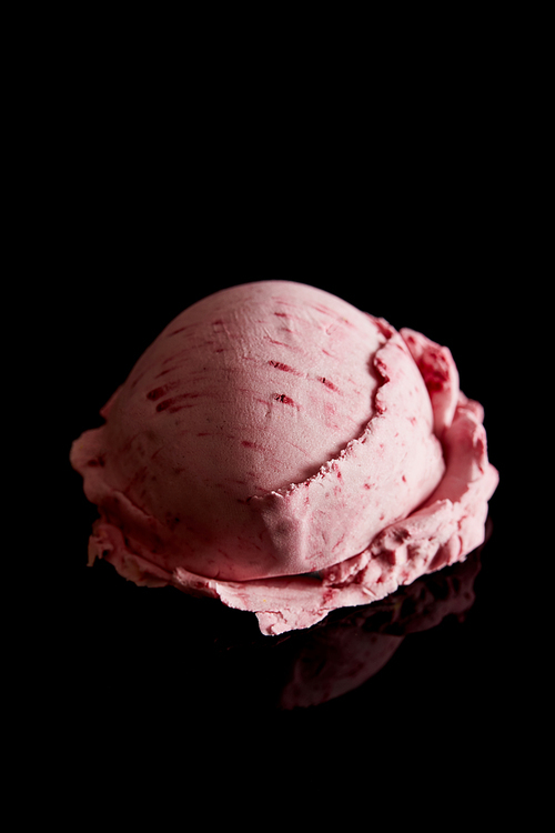delicious pink strawberry ice cream isolated on black