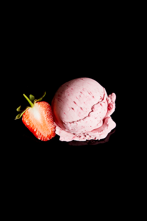 delicious pink strawberry ice cream with fresh berry isolated on black