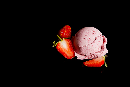 delicious pink strawberry ice cream with fresh berries isolated on black