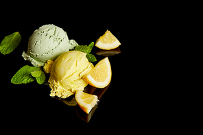 fresh delicious lemon and mint ice cream isolated on black