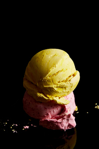 delicious lemon, strawberry ice cream balls on black