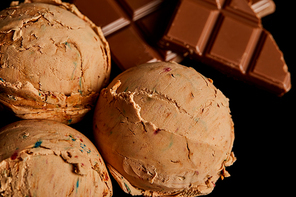 close up view of fresh delicious chocolate ice cream isolated on black
