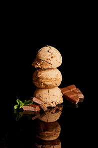 fresh delicious chocolate ice cream with mint leaves isolated on black