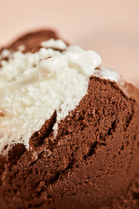 close up view of tasty brown and white ice cream on pink background