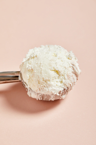 close up view of fresh tasty ice cream ball in scoop on pink background