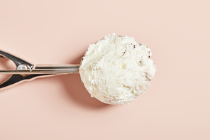 top view of fresh tasty ice cream ball in scoop on pink background