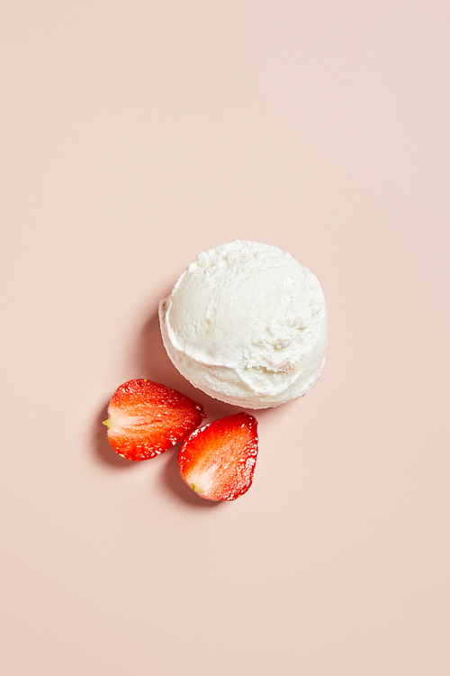 top view of fresh tasty ice cream ball with strawberry on pink background