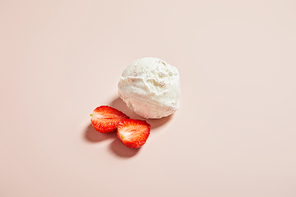 top view of fresh tasty ice cream ball with strawberry on pink background