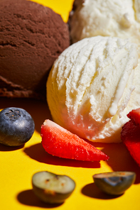 close up view of tasty brown and white ice cream with berries
