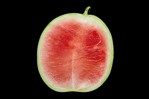 top view of delicious ripe red watermelon half isolated on black