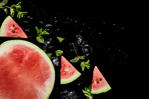 top view of red watermelon slices and half with mint and ice isolated on black