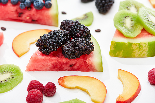 delicious dessert with watermelon and berries on white background