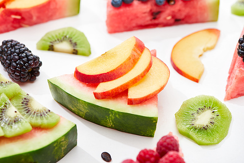 delicious dessert with watermelon, nectarine and berries on white background