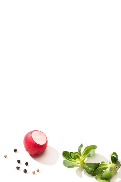 delicious radish and greens with black pepper on white background