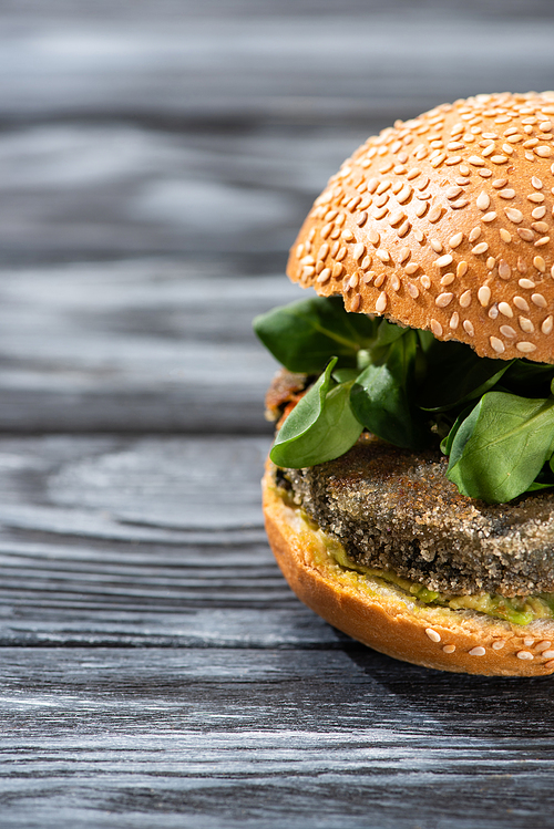 tasty vegan burger with microgreens served on wooden table