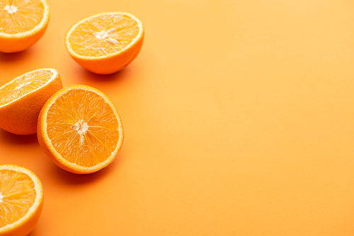 ripe delicious cut oranges on colorful background