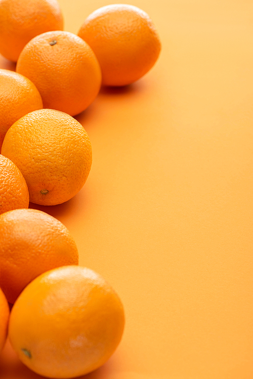 ripe delicious whole oranges on colorful background