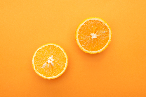 top view of juicy orange slices on colorful background