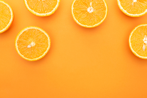 top view of ripe juicy orange slices on colorful background with copy space