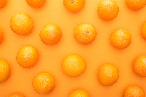 top view of ripe juicy whole oranges on colorful background