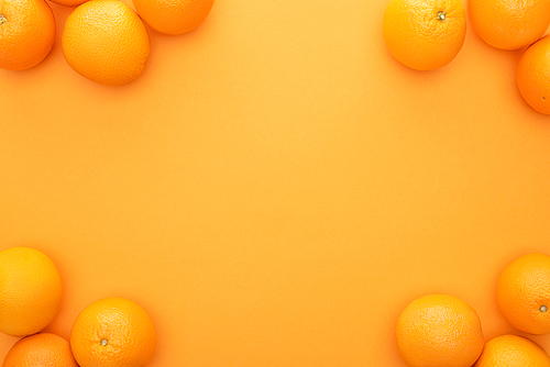 top view of ripe juicy whole oranges on colorful background with copy space