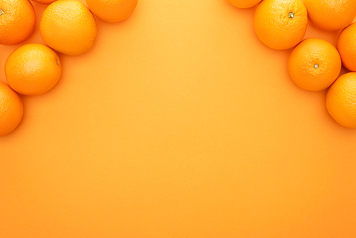 top view of ripe juicy whole oranges on colorful background with copy space