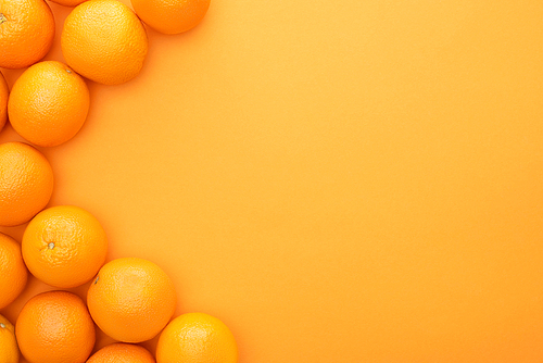 top view of ripe juicy whole oranges on colorful background with copy space