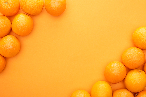 top view of ripe juicy whole oranges on colorful background with copy space