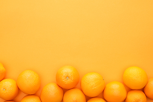 top view of ripe juicy whole oranges on colorful background with copy space