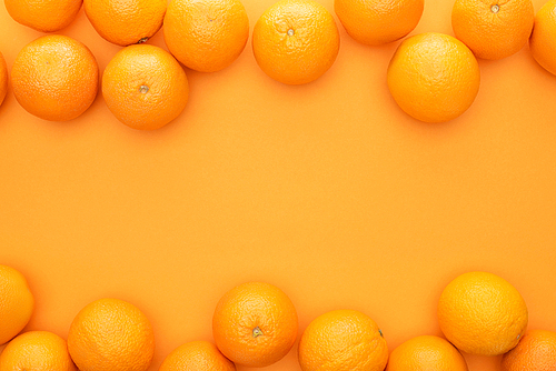 top view of ripe juicy whole oranges on colorful background with copy space