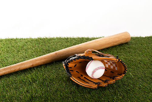 baseball bat, glove and ball on green grass isolated on white, sports betting concept