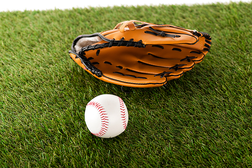 baseball glove and ball on green grass isolated on white, sports betting concept