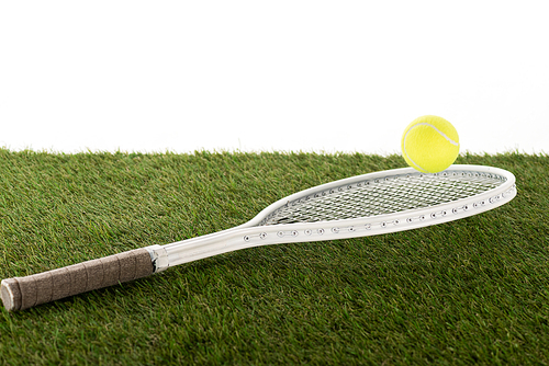 tennis racket and ball on green grass isolated on white, sports betting concept