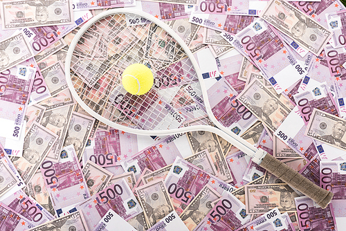 top view of tennis racket and ball on euro and dollar banknotes, sports betting concept