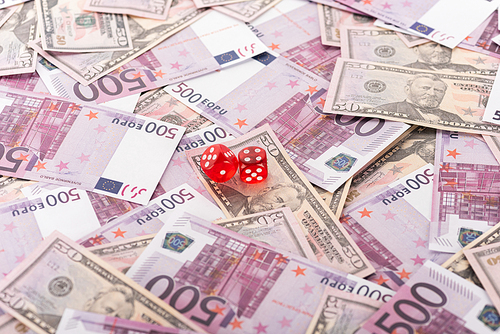 dice on euro and dollar banknotes, sports betting concept