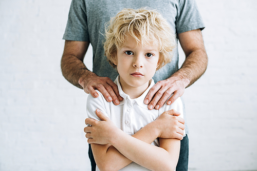 cropped view of father and son having conflict at home