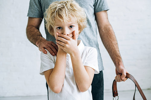 cropped view of father and son having conflict at home