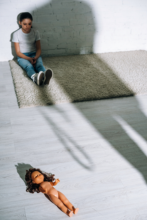 silhouette of man and sad kid sitting on carpet