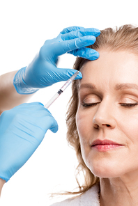 doctor giving beauty injection to middle aged woman with closed eyes Isolated On White