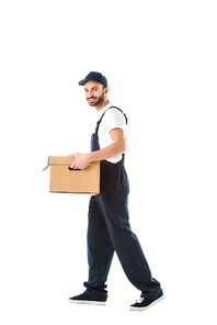 handsome smiling delivery man carrying cardboard box and  isolated on white